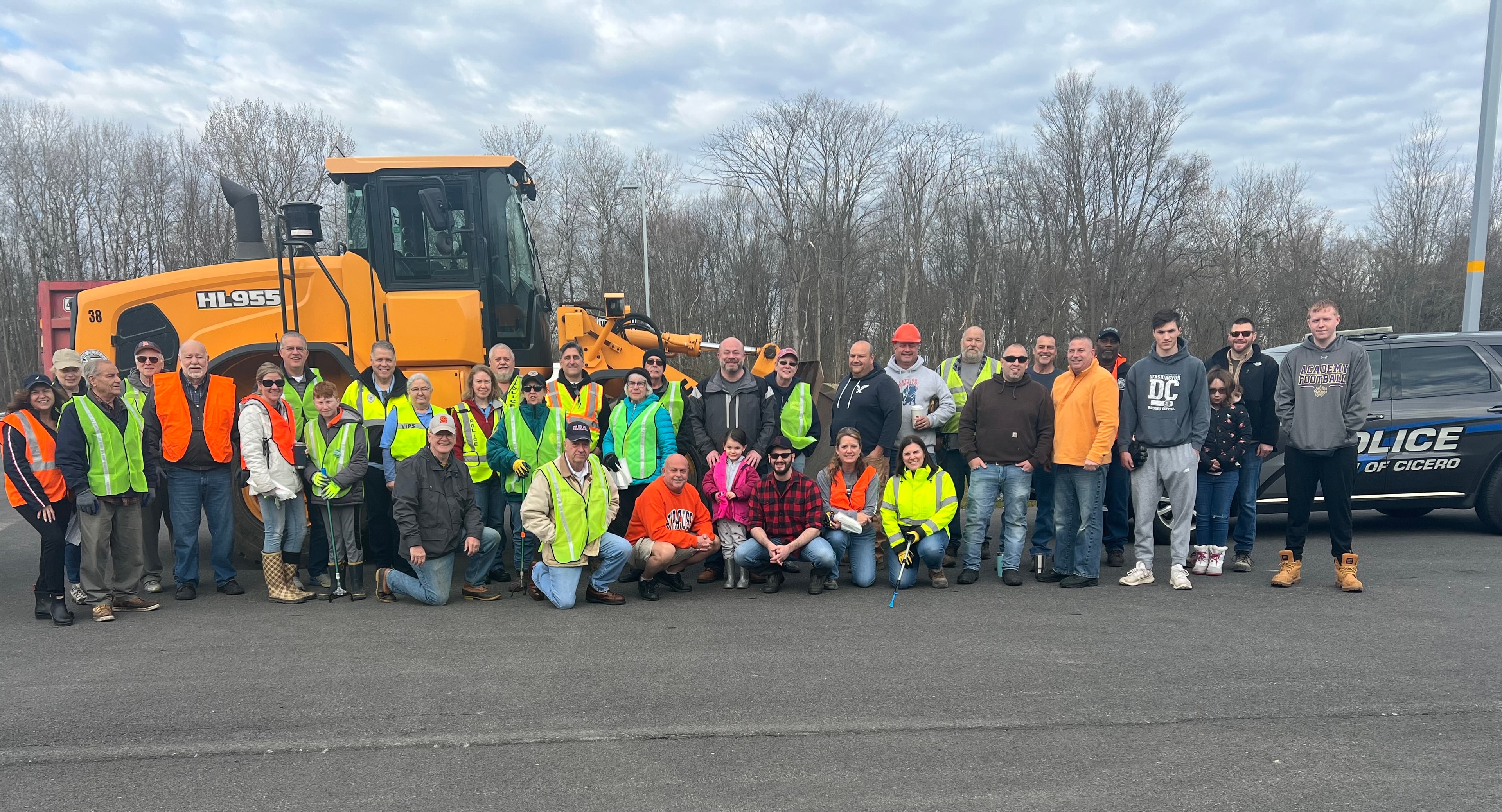 Cicero Earth Day volunteers gathered with equipment and Cicero Police vehicle